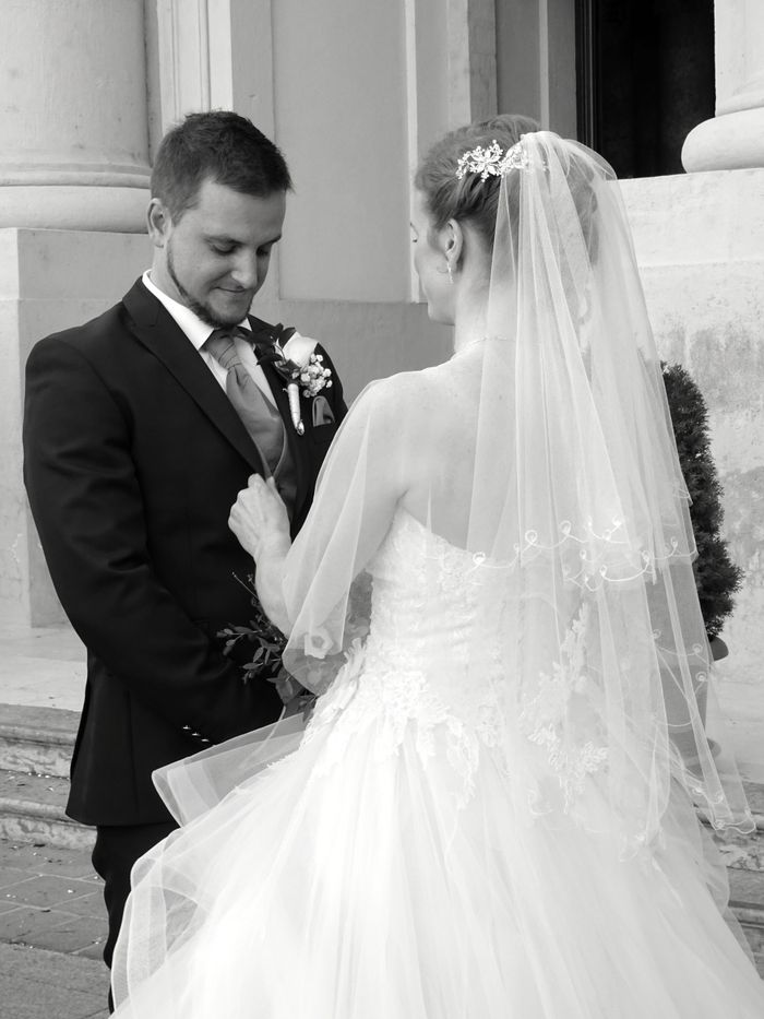 A romantic moment captured between a bride and groom during their outdoor wedding ceremony.