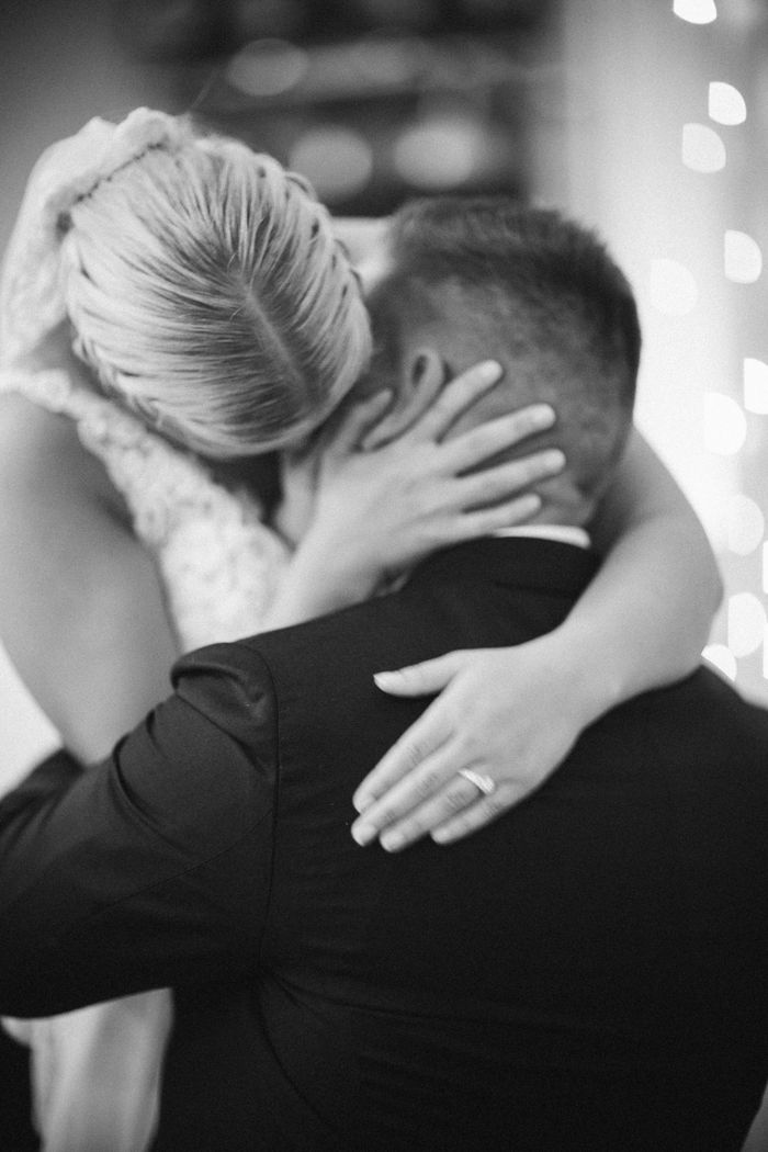 A tender black and white embrace between a bride and groom symbolizing love and intimacy.